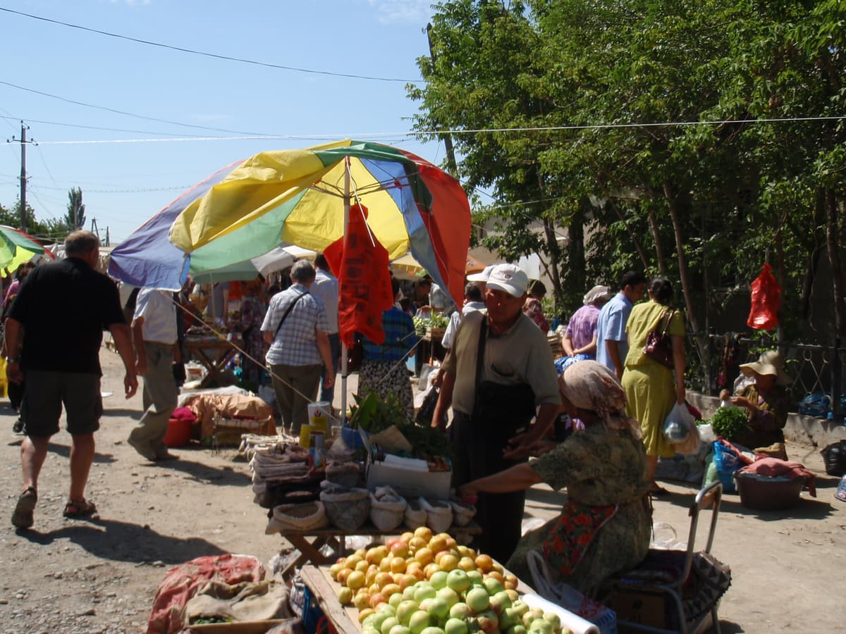 Shoppers at a market under colourful umbrellas in southern Kazakhstan